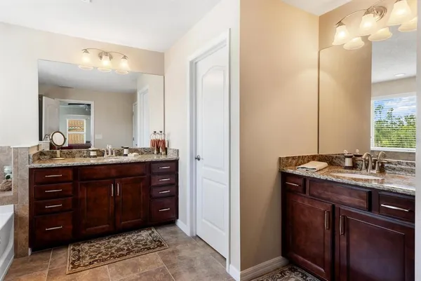 a bathroom with a double vanity sink and a mirror