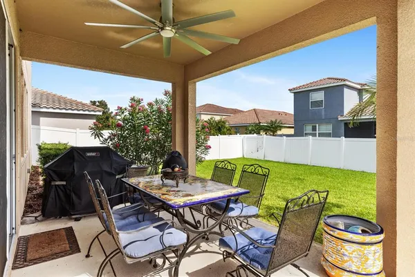 a view of an outdoor dining space with a table and chairs