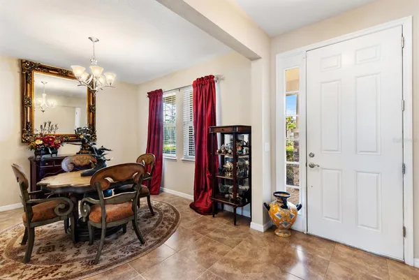 a livingroom with dining area a chandelier and window