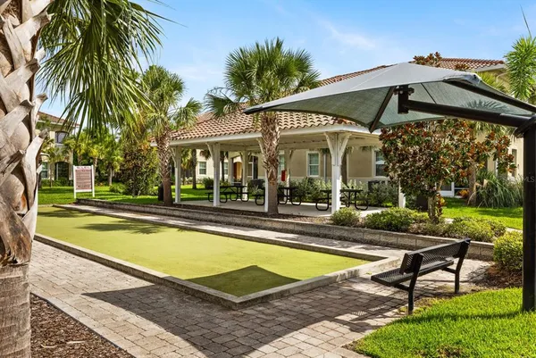 a view of a house with swimming pool and sitting area