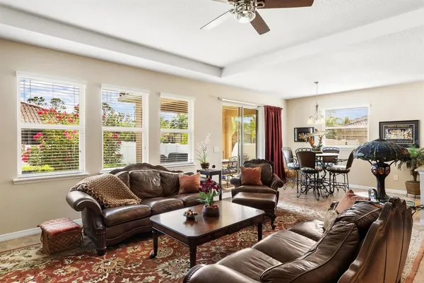 a living room with furniture and floor to ceiling windows