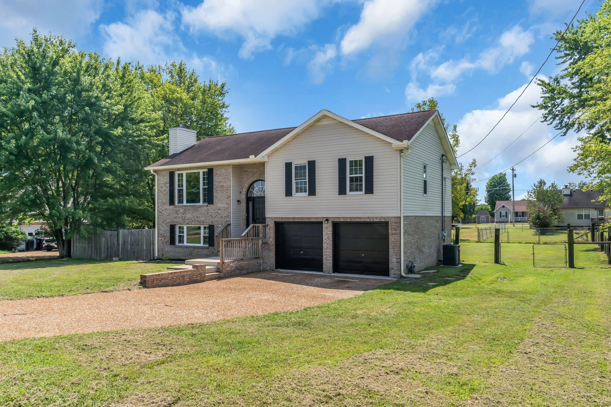 6053 Ebenezer Road Greenbrier, TN 37073 - Photo 3 of 28 a front view of a house with a yard and garage
