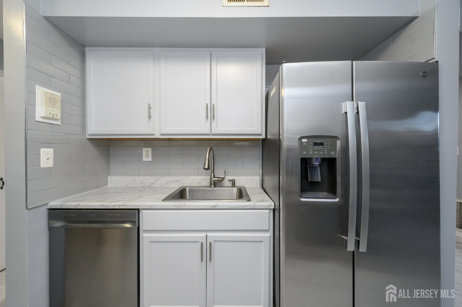 28 Powderhorn Court, Unit A Woodbridge, NJ 07095 - Photo 11 of 26 a kitchen with a sink and a refrigerator
