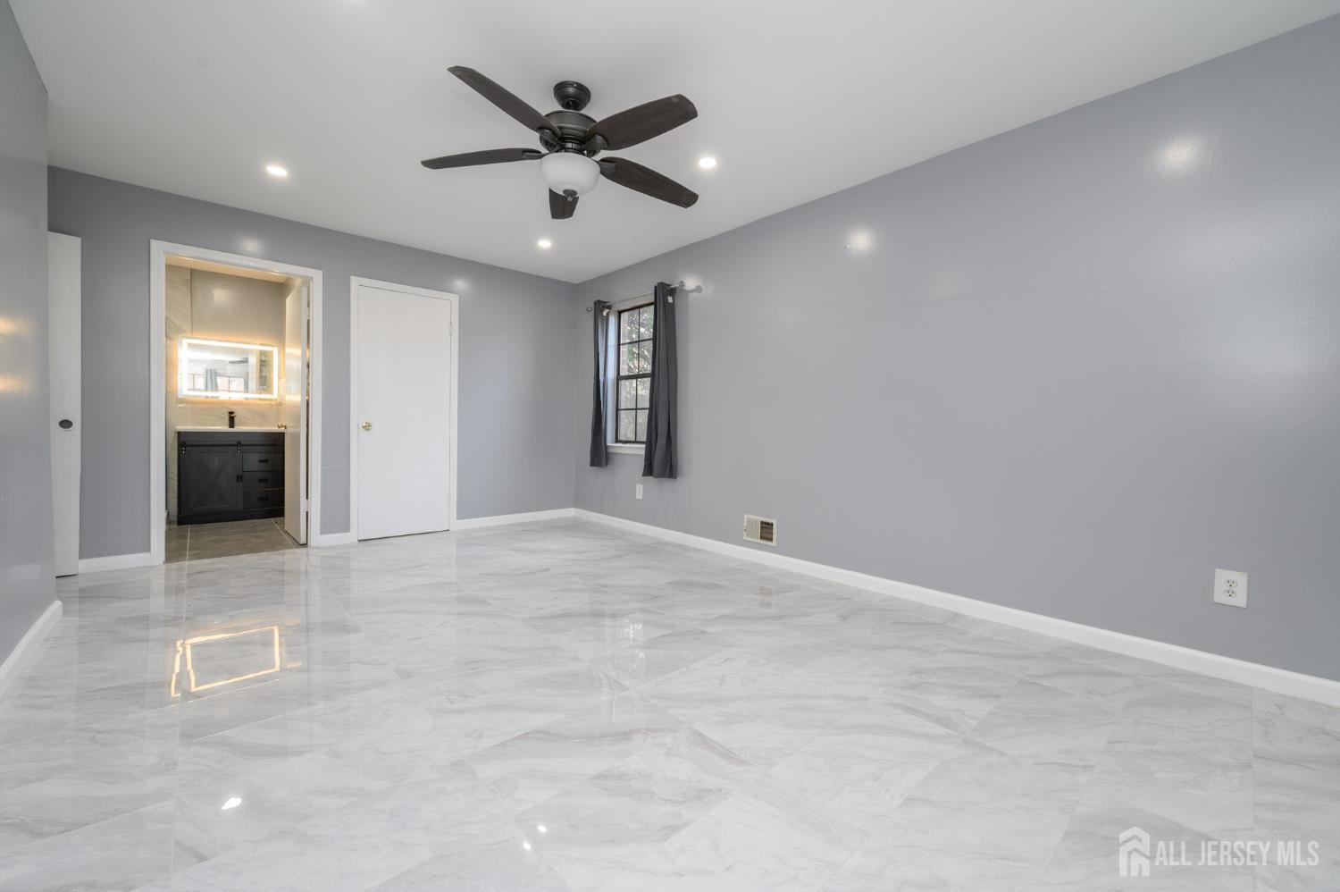 28 Powderhorn Court, Unit A Woodbridge, NJ 07095 - Photo 16 of 26 an empty room with closet and windows