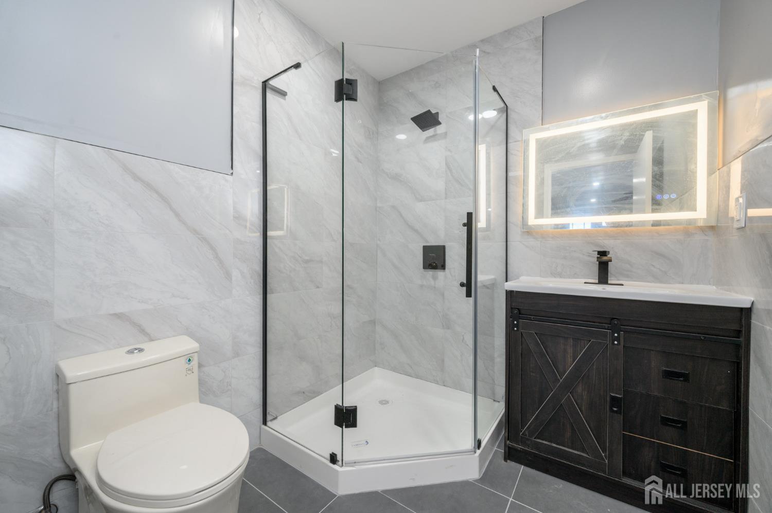 28 Powderhorn Court, Unit A Woodbridge, NJ 07095 - Photo 18 of 26 a bathroom with a sink a toilet and shower