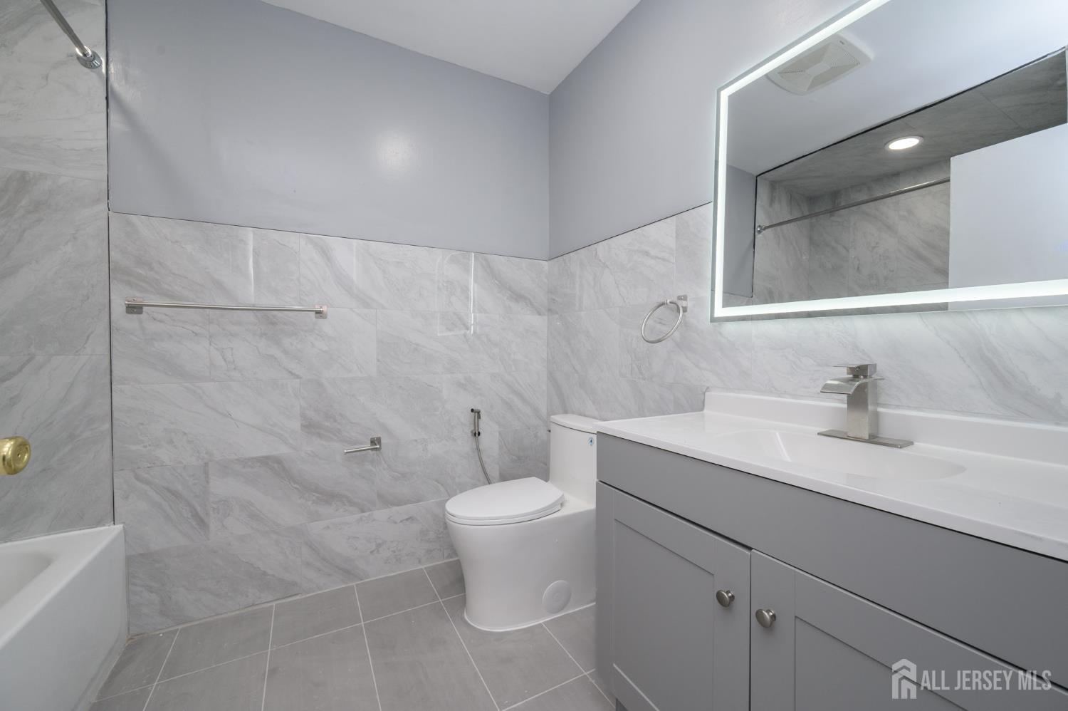 28 Powderhorn Court, Unit A Woodbridge, NJ 07095 - Photo 22 of 26 a bathroom with a granite countertop sink a toilet and a mirror