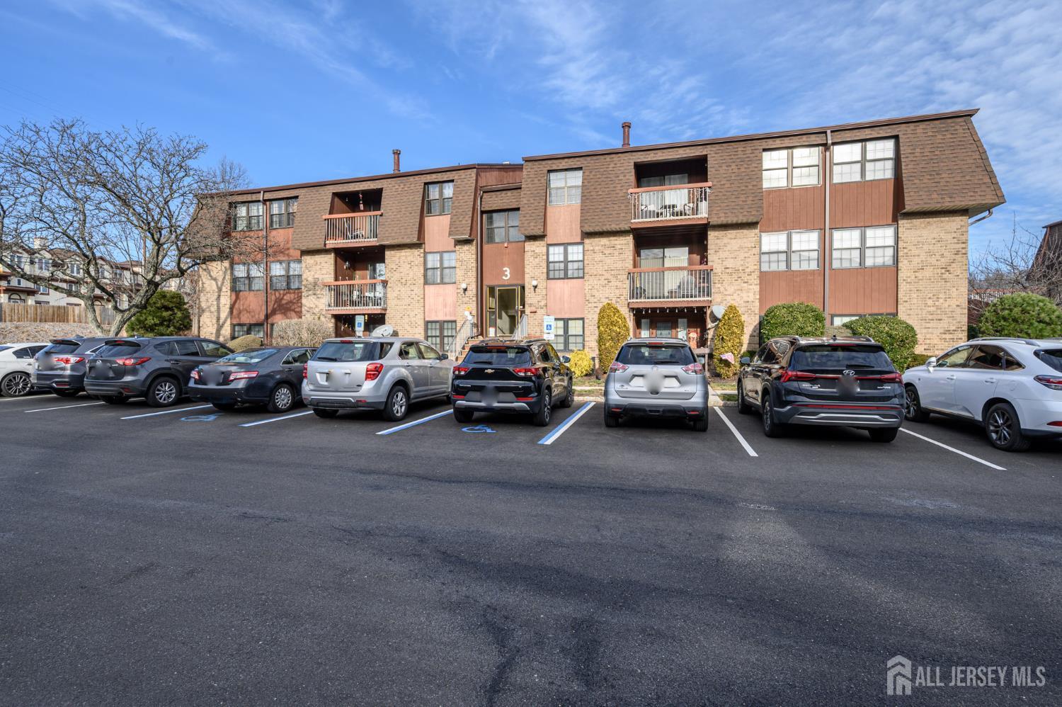 28 Powderhorn Court, Unit A Woodbridge, NJ 07095 - Photo 24 of 26 a view of a cars parked in front of a building