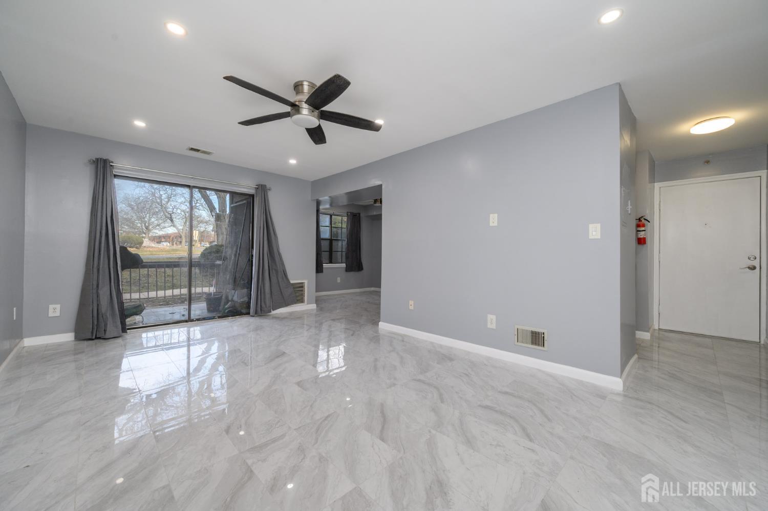 28 Powderhorn Court, Unit A Woodbridge, NJ 07095 - Photo 4 of 26 a view of empty room with wooden floor and fan
