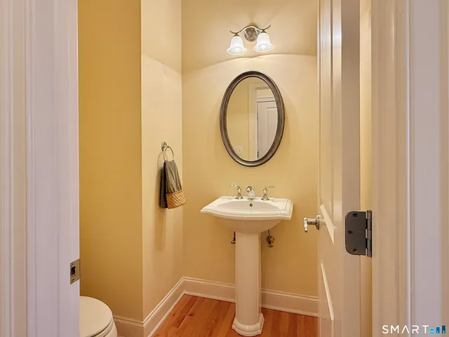 a bathroom with a sink mirror vanity and toilet