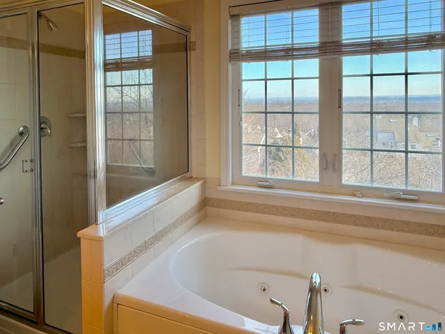 a bathroom with bathtub and window