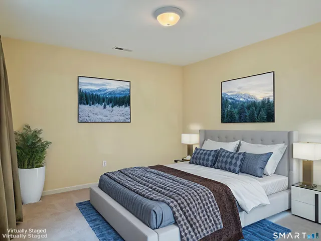 a bedroom with bed and a potted plant