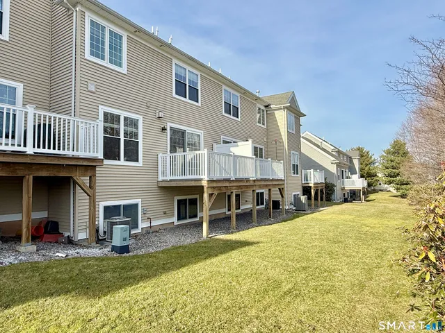 a view of a house with a yard and balcony