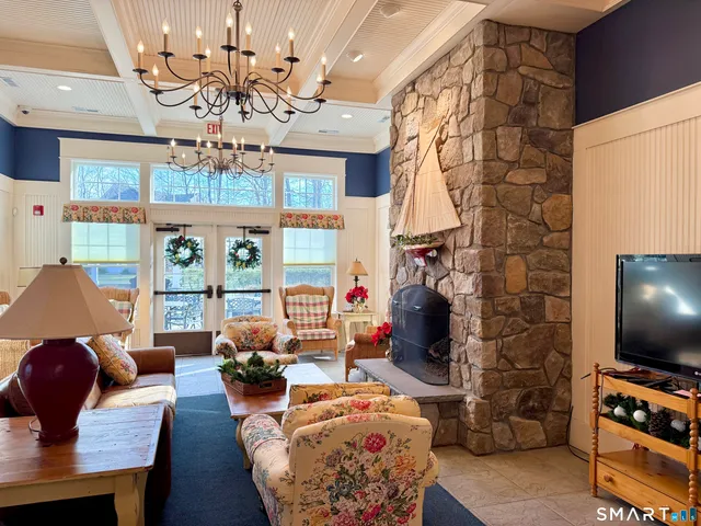 a living room with fireplace furniture and a flat screen tv