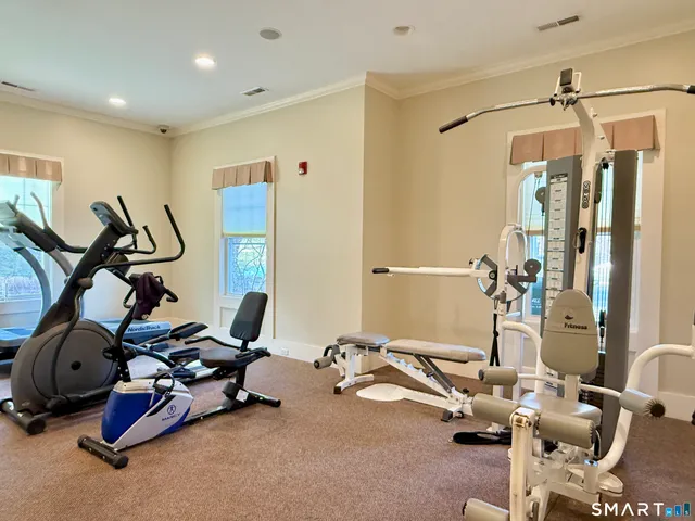 a room with gym equipment and windows