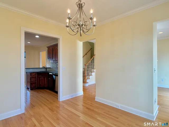 a view of a room with wooden floor and entryway