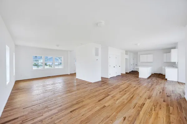 a view of a kitchen with wooden floor and electronic appliances