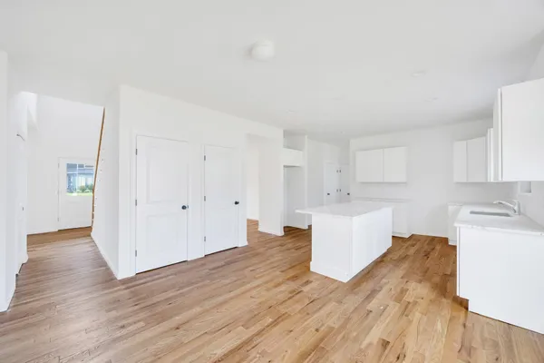 a kitchen with stainless steel appliances granite countertop a stove a sink and a wooden floors
