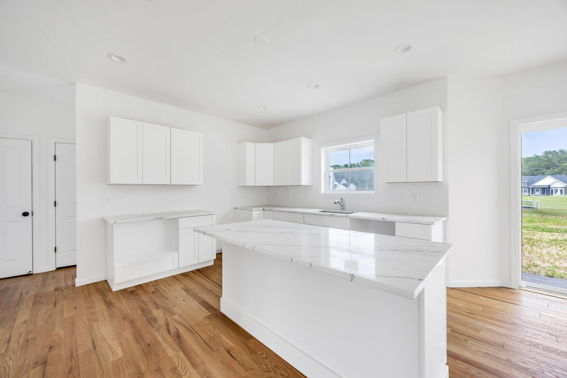 Lot #3 Cardinal Court Ridge, NY 11961 - Photo 22 of 31 a kitchen with wooden floors and white cabinets
