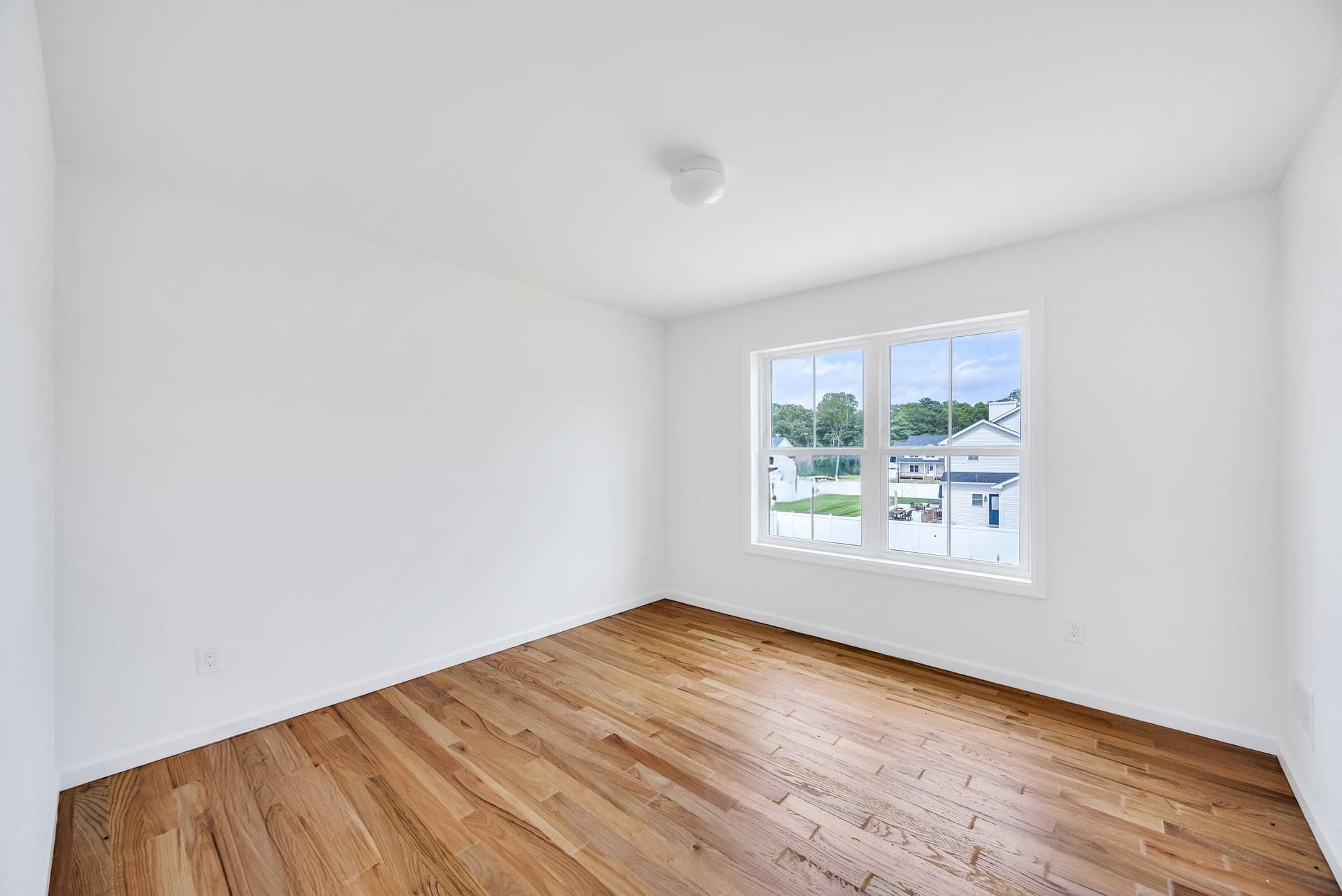 Lot #3 Cardinal Court Ridge, NY 11961 - Photo 24 of 31 an empty room with wooden floor and windows