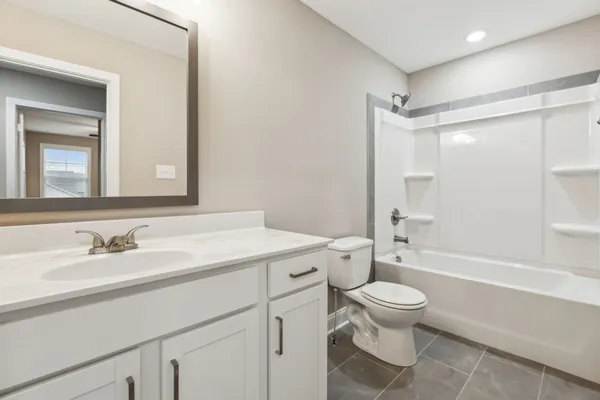 a kitchen with a refrigerator sink and wooden cabinets