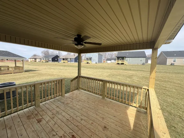 a view of an empty room with a ceiling fan
