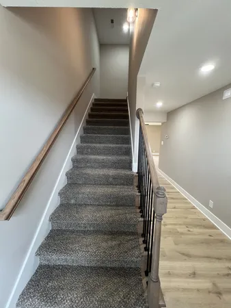 an empty room with windows and ceiling fan