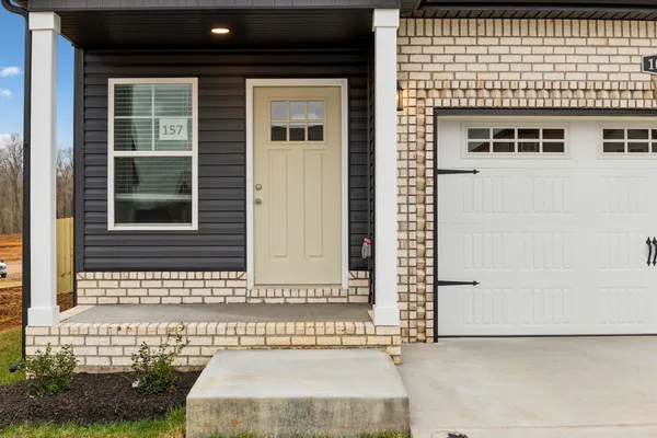 a view of a kitchen with a stove cabinets a ceiling fan and wooden floor