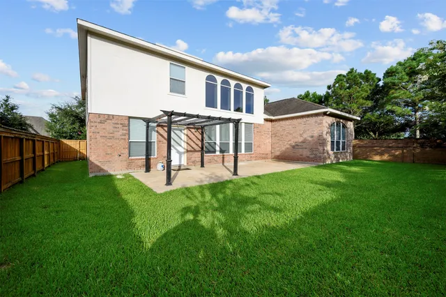 a backyard of a house with table and chairs