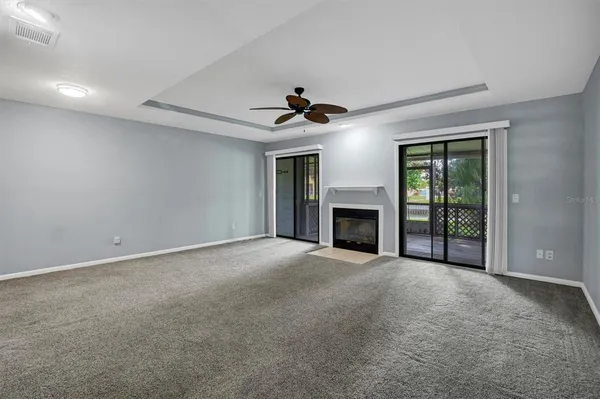 a view of an empty room with a fireplace and a window