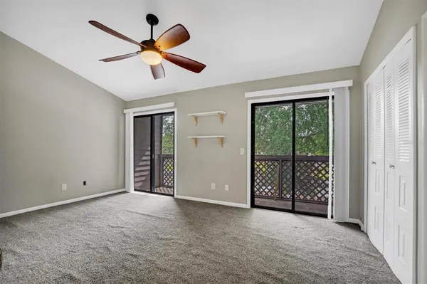 a view of a ceiling fan and a large window