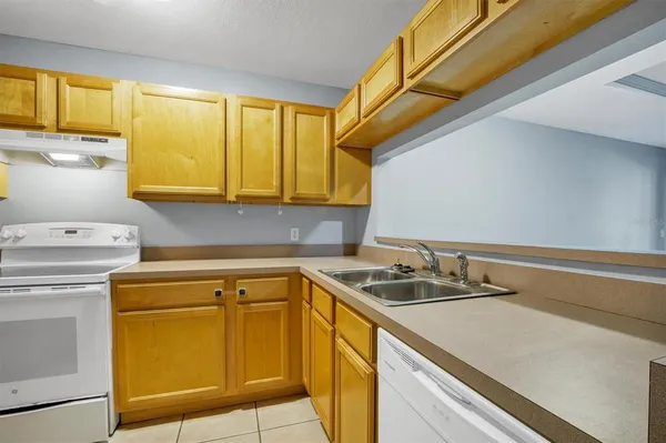 a utility room with sink dryer and washer