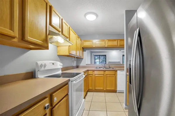 a kitchen with a sink a stove and refrigerator