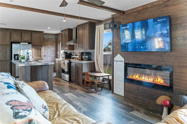 a kitchen with stainless steel appliances granite countertop a stove top oven a sink dishwasher and cabinets with wooden floor