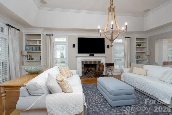 a living room with furniture a fireplace and a flat screen tv