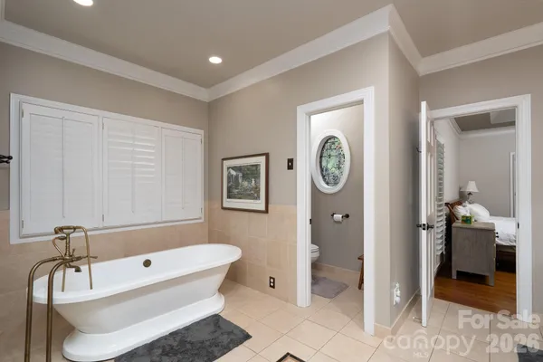 a bathroom with a tub a sink and a shower