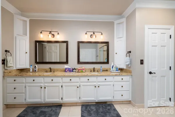 a bathroom with a double vanity sink and mirror