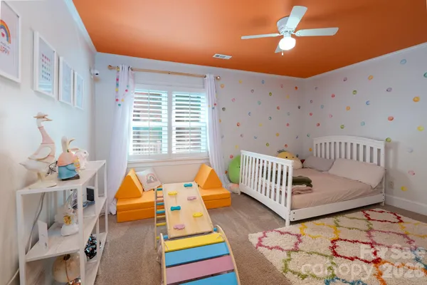 a bedroom with furniture and a wooden floor