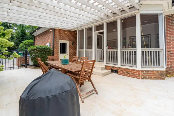 a view of a patio with a table and chairs
