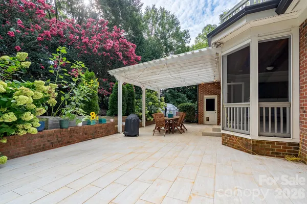 a view of a patio with table and chairs and potted plants