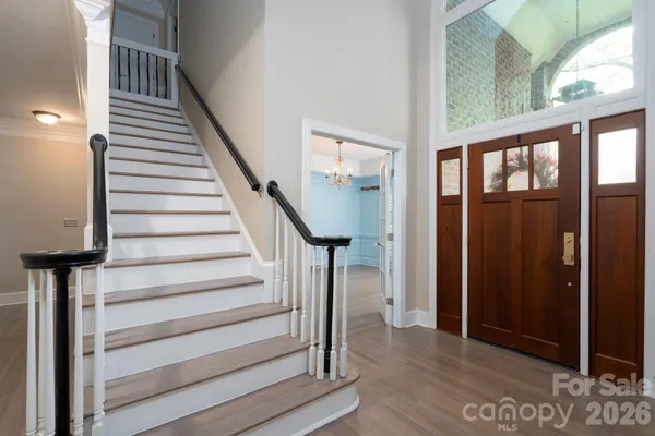 a view of entryway and hall with wooden floor