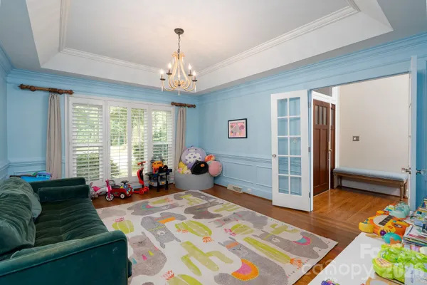 a bedroom with furniture and a chandelier