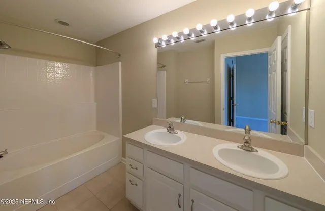 a view of a house with a big yard and large trees