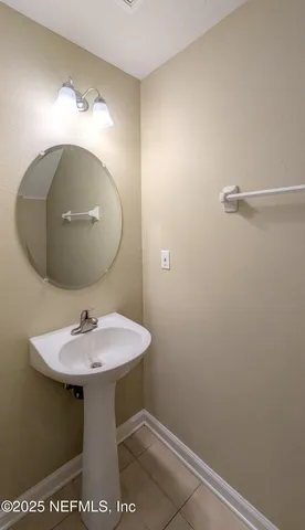 a bathroom with a sink and mirror