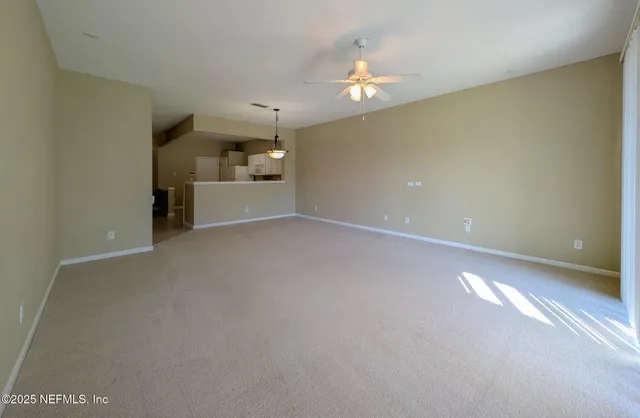 a view of a room with a kitchen