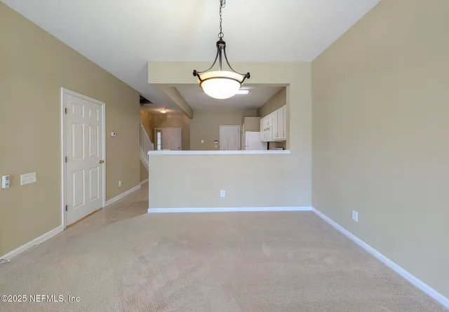 a view of a room with a ceiling fan