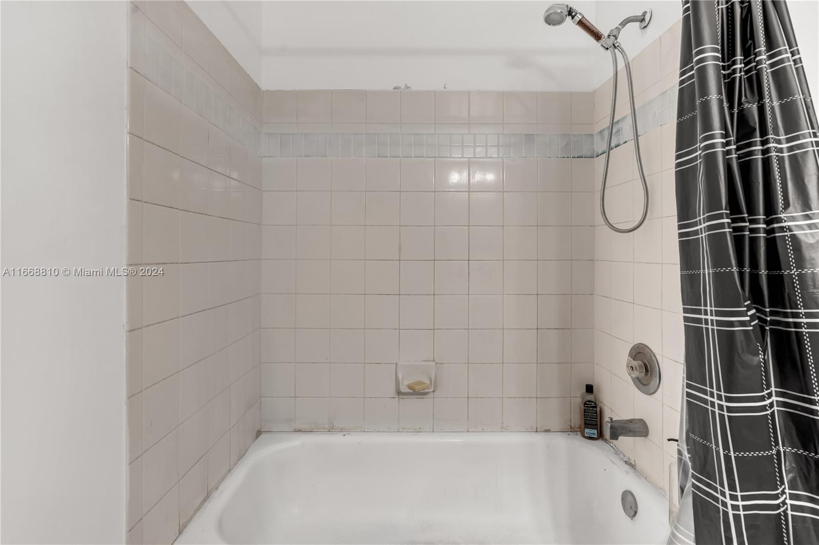 14807 Balgowan Road, Unit 10212 Miami Lakes, FL 33016 - Photo 11 of 32 a bathroom with a bath tub with a shower