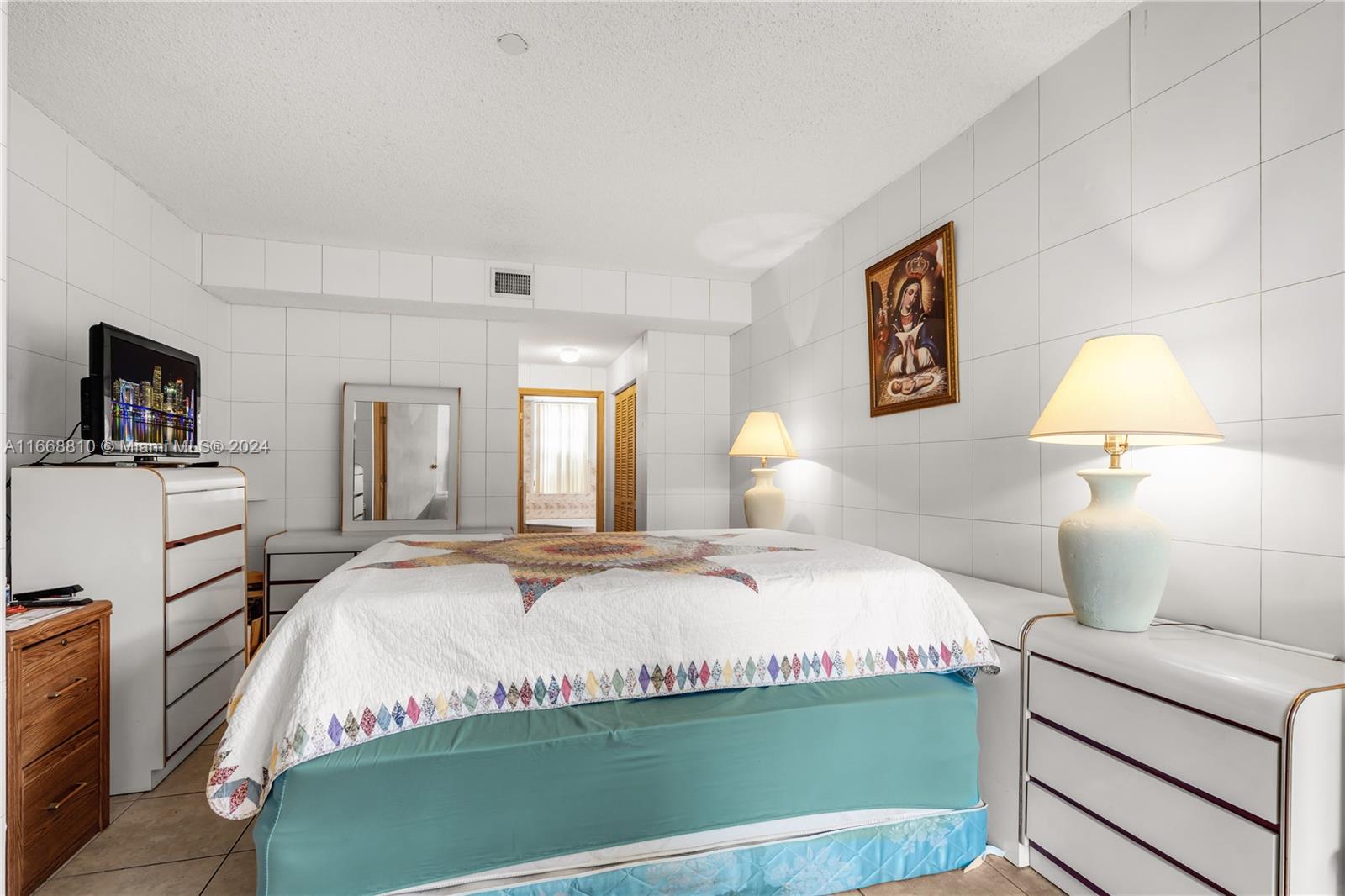 14807 Balgowan Road, Unit 10212 Miami Lakes, FL 33016 - Photo 15 of 32 a bedroom with a bed and wooden floor