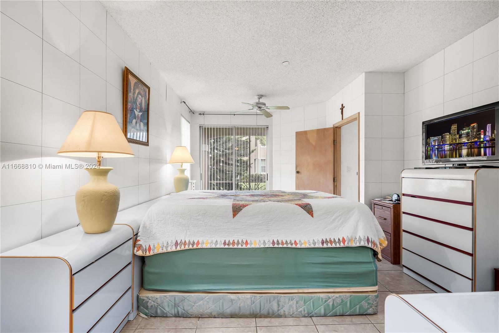 14807 Balgowan Road, Unit 10212 Miami Lakes, FL 33016 - Photo 16 of 32 a bedroom with a bed and a window