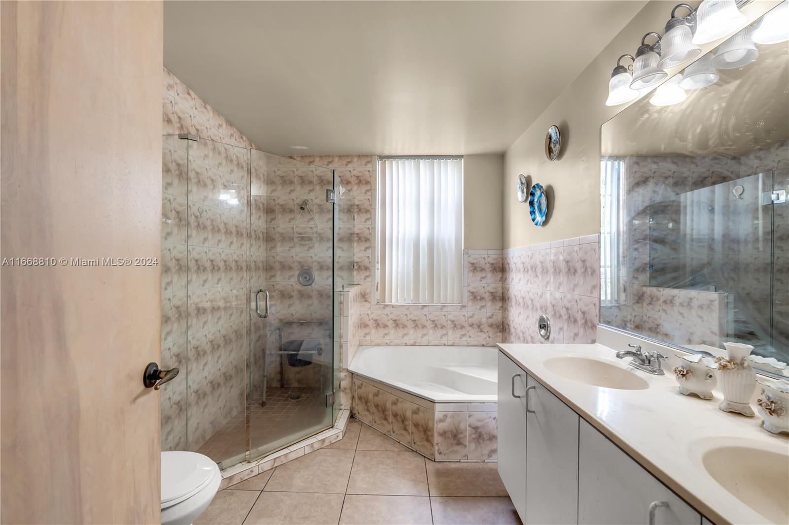 14807 Balgowan Road, Unit 10212 Miami Lakes, FL 33016 - Photo 17 of 32 a spacious bathroom with a granite countertop sink a toilet and shower