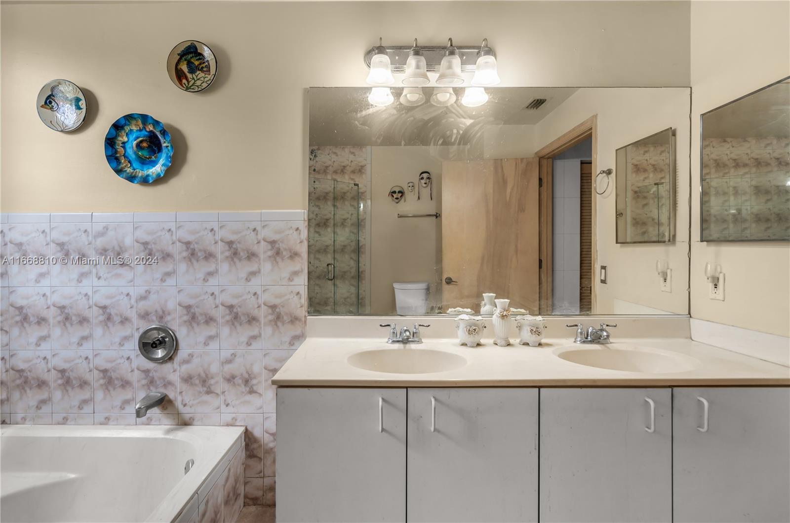 14807 Balgowan Road, Unit 10212 Miami Lakes, FL 33016 - Photo 18 of 32 a bathroom with a sink and a mirror